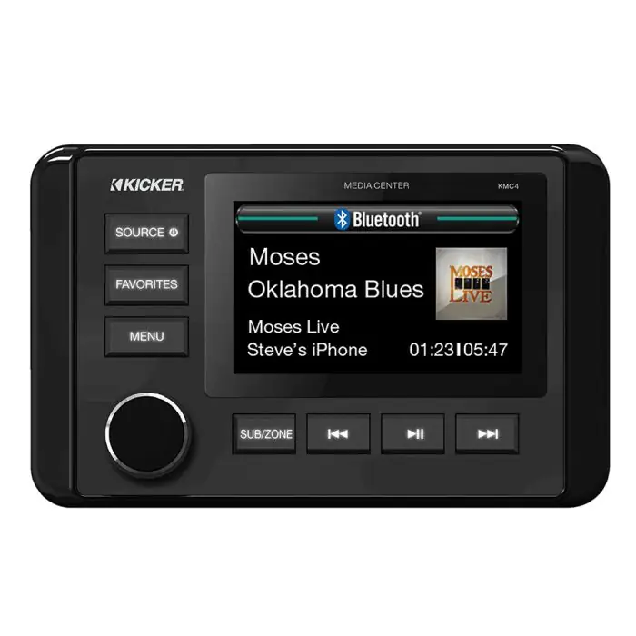 The image shows a black Kicker media center displaying Moses - Oklahoma Blues playing via Bluetooth from iPhone. It features large buttons and a dial.